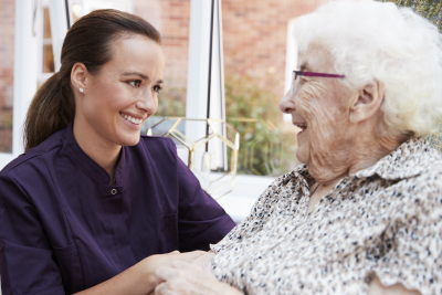 caregiver and senior woman smiling