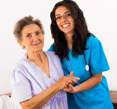 senior woman and female caregiver smiling