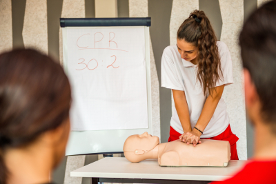 pretty woman demonstrating the proper way on doing cpr