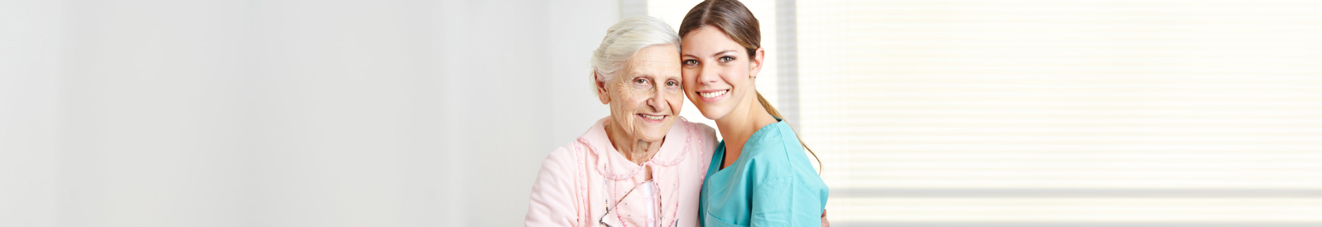 caregiver and senior woman smiling