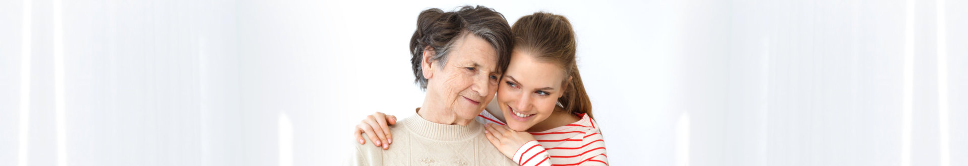 caregiver and senior woman smiling